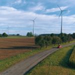a dirt road in a grassy field