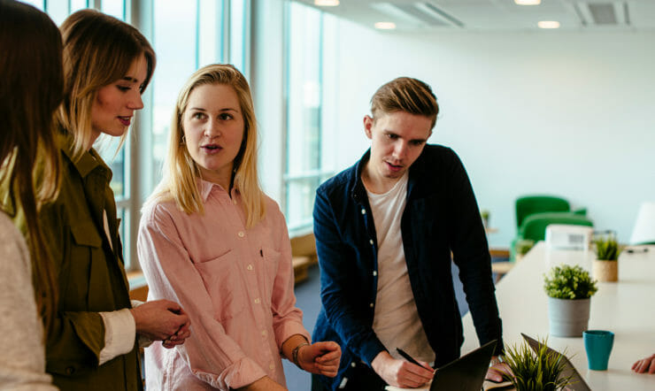 a group of people standing next to a person
