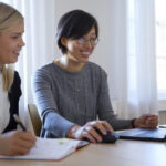 Two women in an office looking at a computer